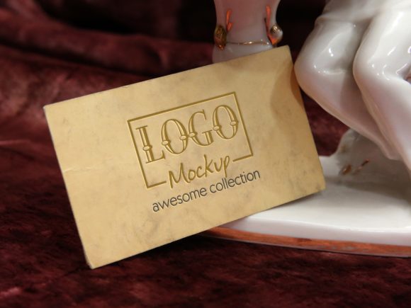 Logo Mockup with Porcelain Figurine in Background: A Unique Design for Travel and Tourism